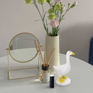 Magnetic Goose Key Holder in white resin with a yellow beak and feet, standing on a round base