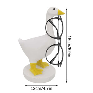 Magnetic Goose Key Holder in white resin with a yellow beak and feet, holding black-framed glasses by its beak