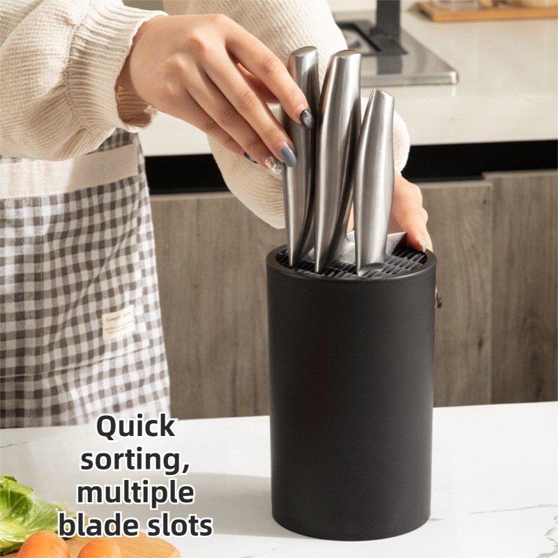 Matte Black Modern knife block with a cylindrical matte black body and multiple blade slots holding stainless steel knives