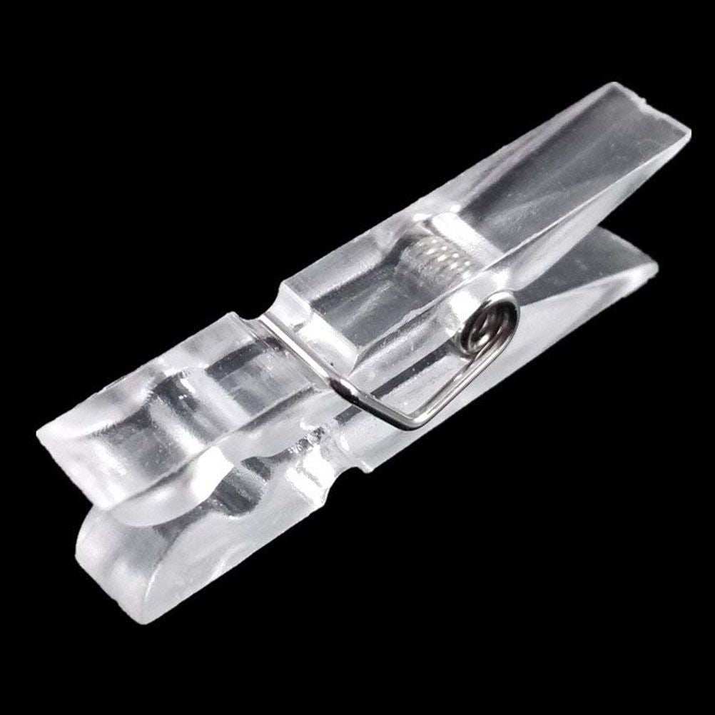 Mini Transparent Plastic clip in clear plastic with a small metal spring and ridged gripping jaws