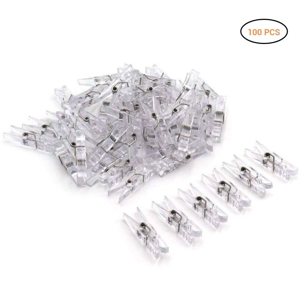 Mini Transparent Plastic clips in clear plastic with small metal springs, shown in a loose pile with 100 pieces.