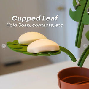 Mirror-Mount Half-Leaf Monstera soap holder with bright green cupped leaf and matching stem, holding two bars of soap