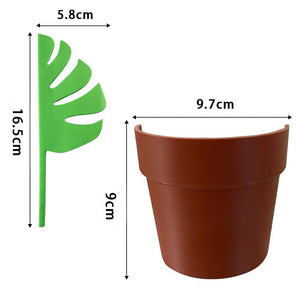 Planter organiser with green plastic Monstera half-leaf divider and brown ABS base, featuring a tropical split-leaf shape