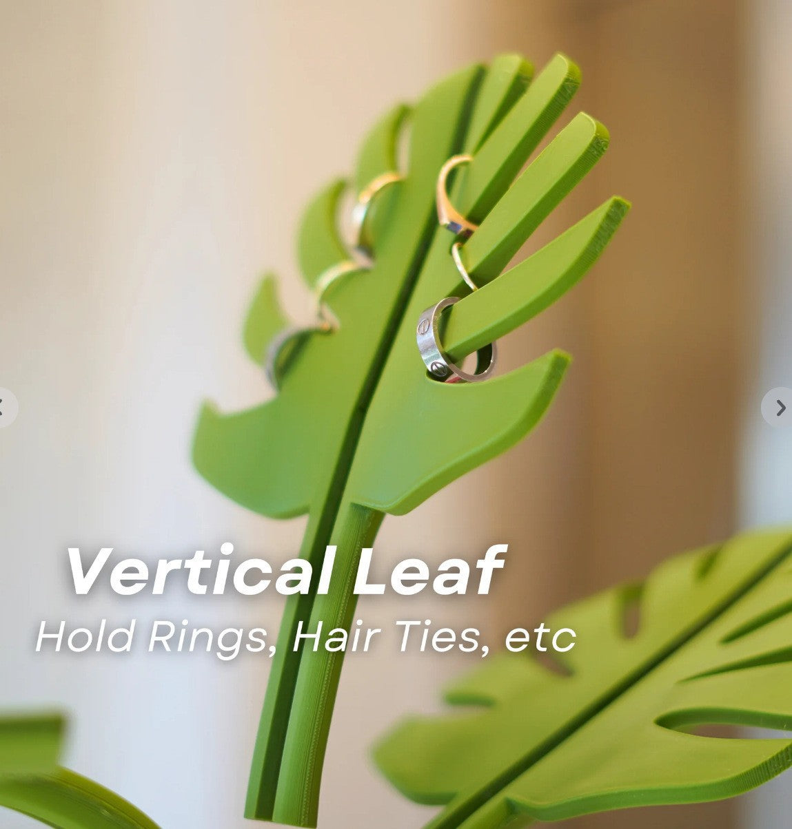 Mirror-Mount Half-Leaf Monstera organiser in bright green plastic, with leaf-shaped slots holding rings and hair ties