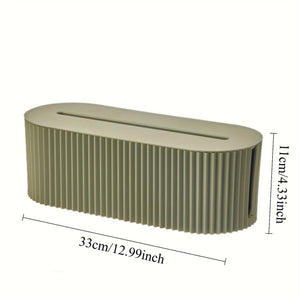 Multi-Scene Cable Storage Box in muted olive-green plastic, with a long top cable slot and ribbed sides