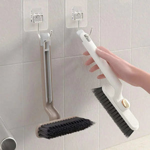 Multifunctional 360° Rotary Cleaning Brush with a white curved plastic handle and dense dark bristles on a rotating head
