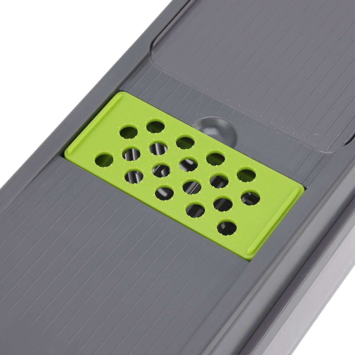 Multifunctional Vegetable Cutter with a lime green perforated grating insert set into a grooved grey plastic base