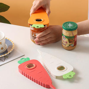 Orange Carrot-Shaped Multi-Function Bottle Opener in ridged plastic, shown gripping a jar lid; red and white versions nearby