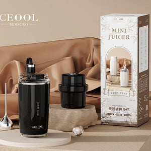 Personal Juicer in a black cylindrical cup with a clear blade lid, alongside a separate black attachment and retail box