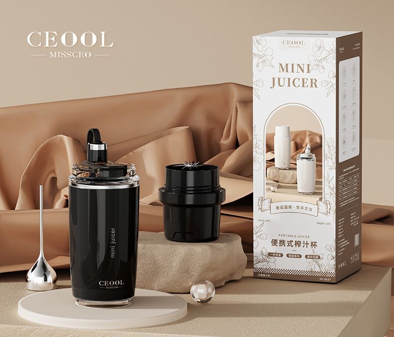 Personal Juicer in a black cylindrical cup with a clear blade lid, alongside a separate black attachment and retail box