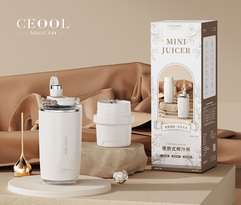 Personal Juicer with a white cylindrical body, clear blending lid, and separate white drinking cup with a compact design