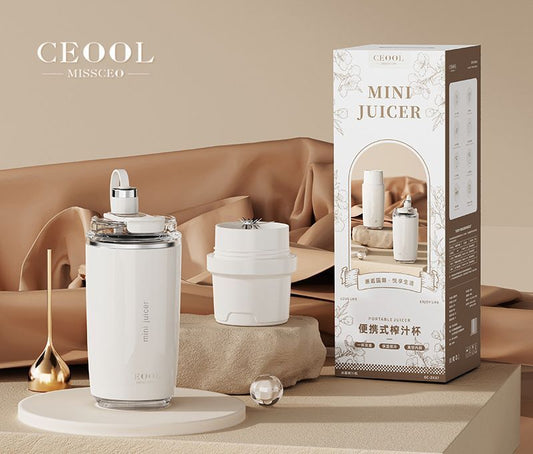 Personal Juicer with a white cylindrical body, clear blending lid, and separate white drinking cup with a compact design