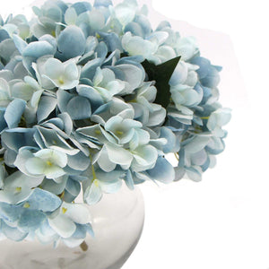 Premium Faux Hydrangea with pale blue and white layered petals, green leaves and a smooth glass vase