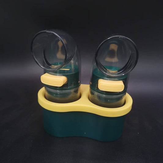 Quantitative Salt & Spice Dispenser Set with two dark green clear plastic shakers, yellow push buttons and matching storage base