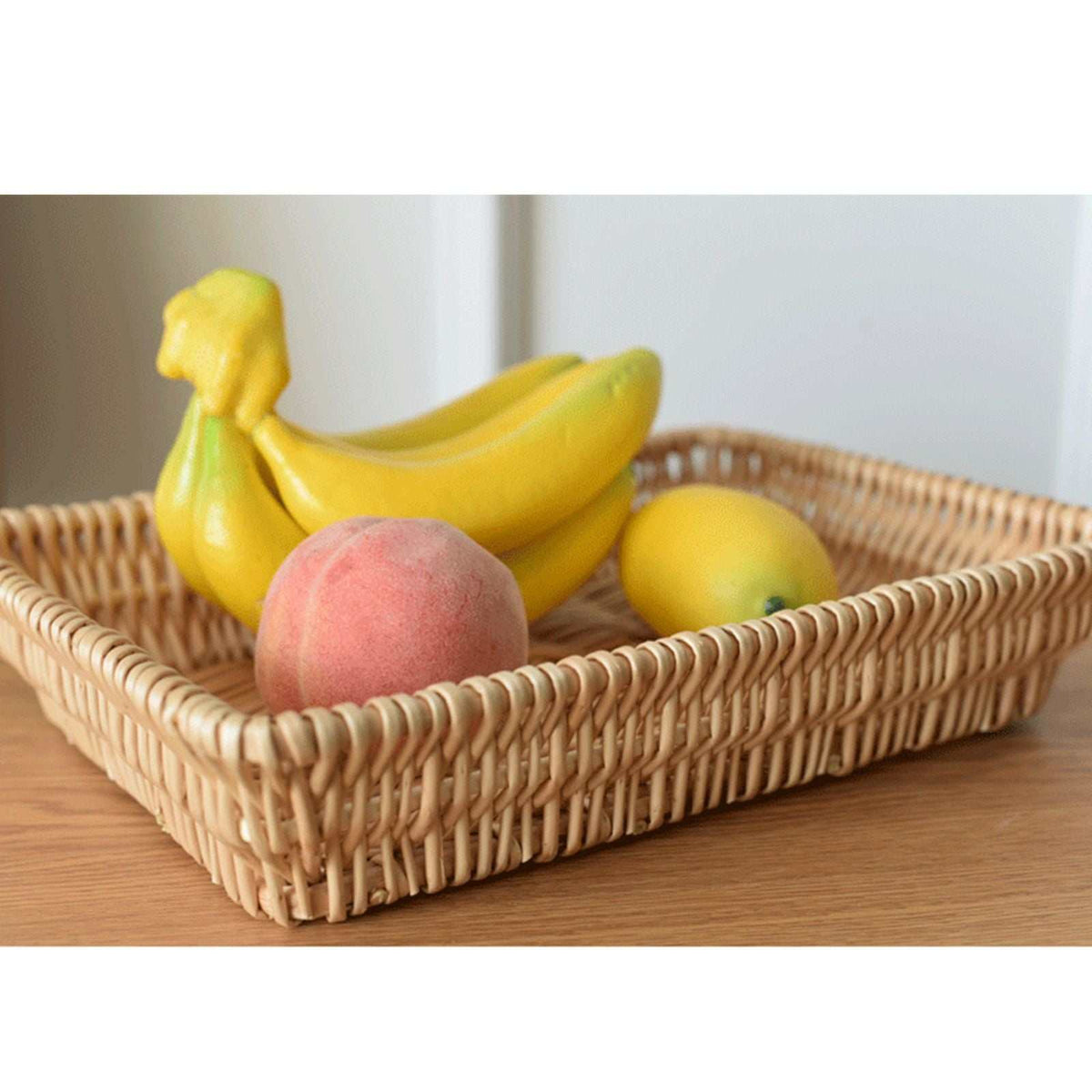 Rattan Storage Basket in natural woven material with a rectangular shape and raised sides, holding colorful fruit
