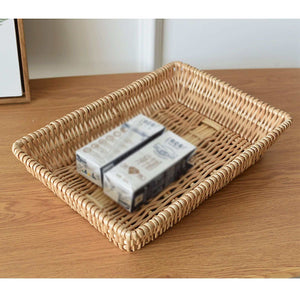Rattan Storage Basket in natural woven rattan, rectangular with raised sides and a sturdy braided rim