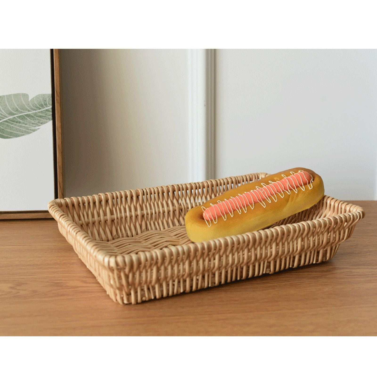 Rattan Storage Basket in natural woven rattan, with a low rectangular shape and raised sides holding a hot dog