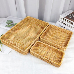 Rattan Tray Tabletop Organization featuring three golden natural rattan trays with hand-woven patterns and raised edges