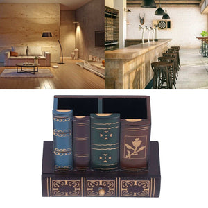 Retro Style Pencil Holder shaped like stacked dark leather books with gold designs and a three-panel drawer front