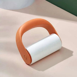 Reusable Lint Roller with orange plastic handle and white adhesive roll designed for removing lint and pet hair