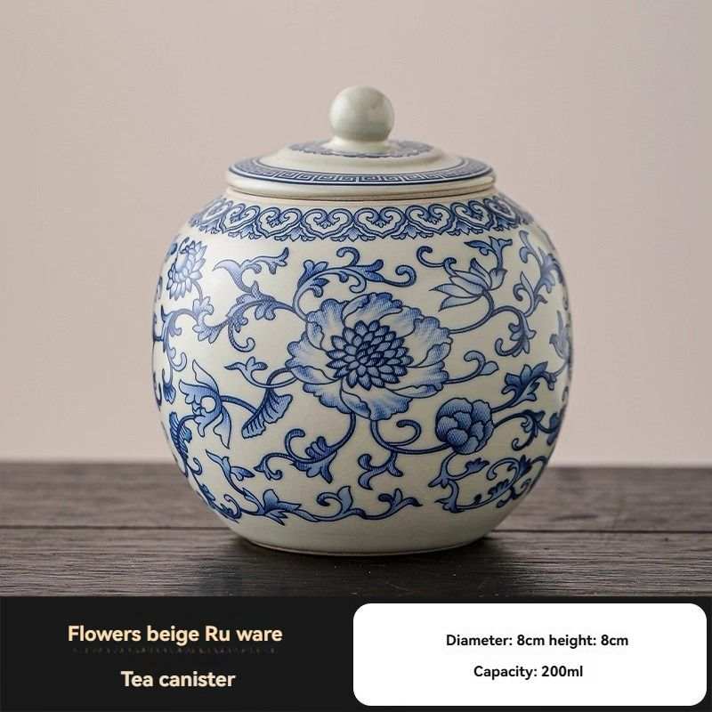 Ru Kiln tea jar with cream ceramic body, blue floral scrollwork and a matching round lid with knob