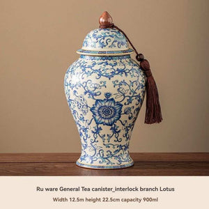 Ru Kiln tea jar in glossy cream ceramic with blue floral vines and lotus, domed lid and decorative tassel