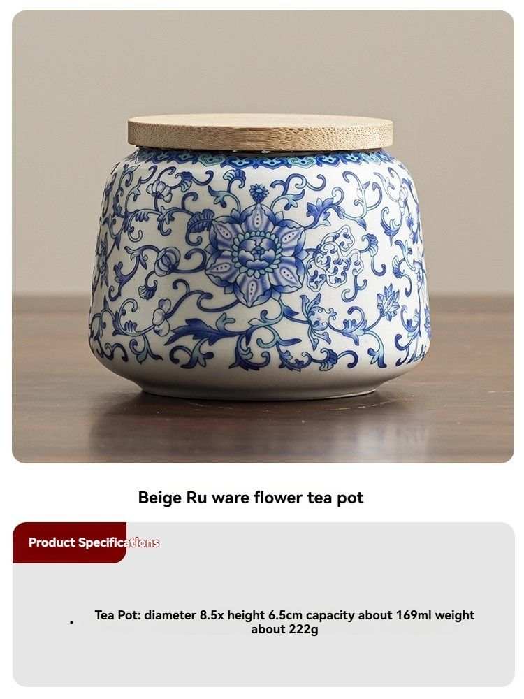 Ru Kiln tea jar in white ceramic with ornate blue floral scrollwork, rounded body and flat beige lid