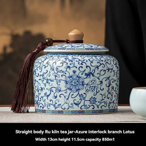 Ru Kiln tea jar in white ceramic with dense blue floral and interlocking branch motifs, rounded body and fitted lid