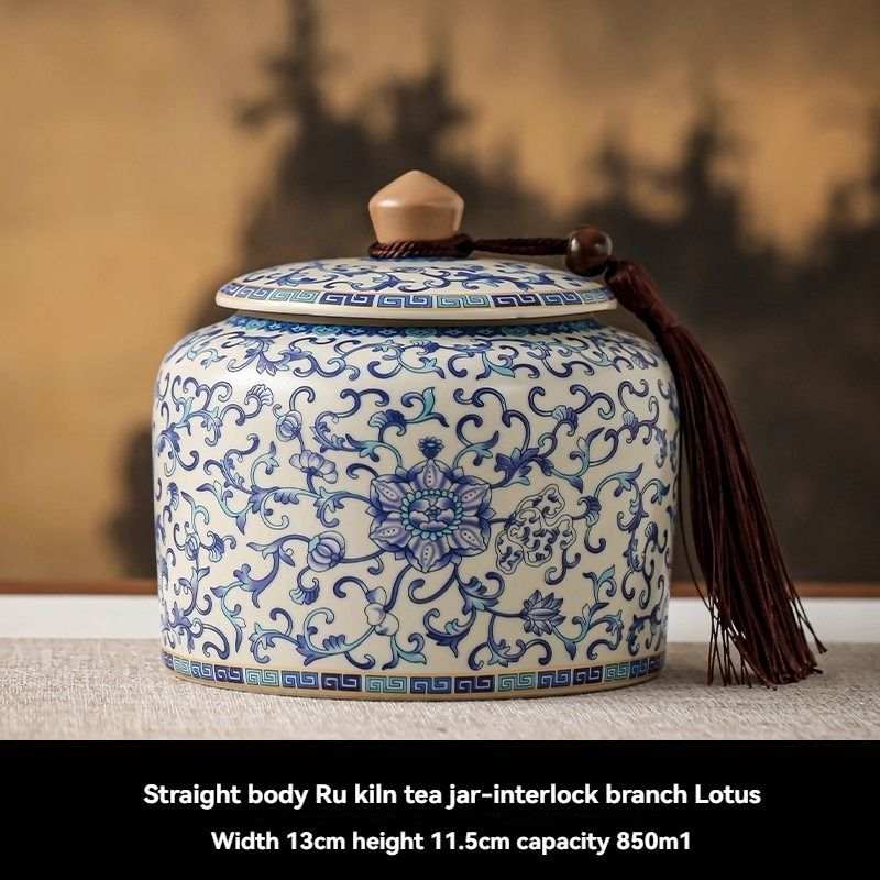 Ru Kiln tea jar in white ceramic with intricate blue interlocking floral and lotus patterns, topped with a fitted lid