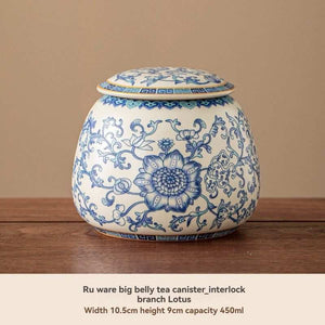 Ru Kiln tea jar in white ceramic with intricate blue floral decoration, rounded body and matching fitted lid
