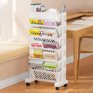 Six Tier Rolling Storage Cart in white plastic with six angled shelves, filled with magazines and books, on caster wheels