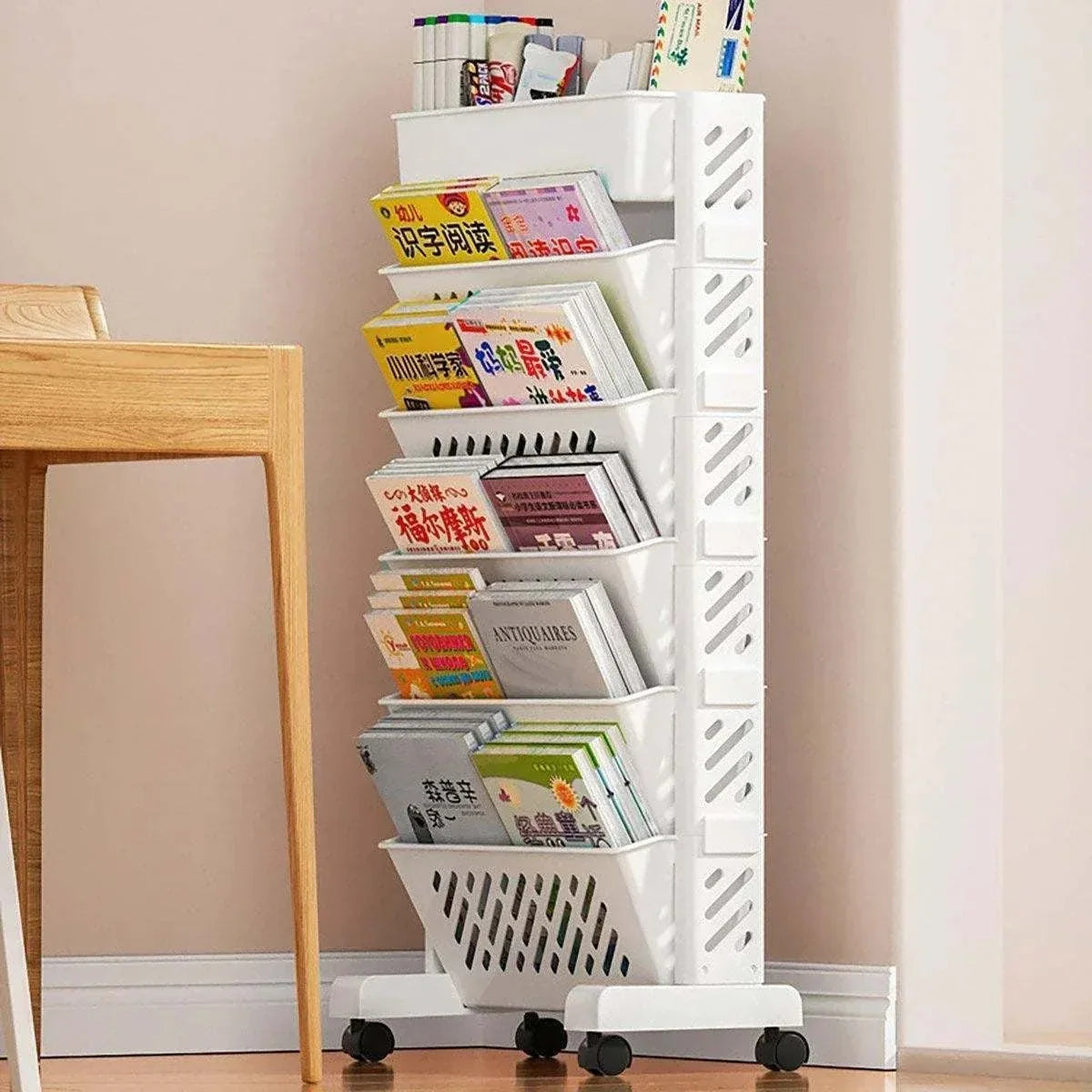 Six Tier Rolling Storage Cart in white plastic with six angled magazine compartments, slotted sides and black caster wheels