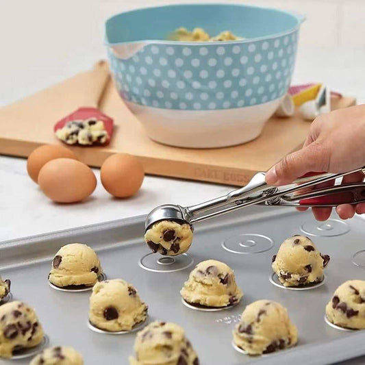 Stainless Steel Ice Cream Spoon with a shiny silver finish and rounded scoop, portioning chocolate chip dough