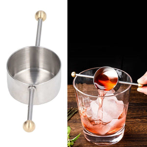 Stainless Steel Measuring Cup with a brushed interior, polished silver bowl and double-ended handle with gold-tone ball tips