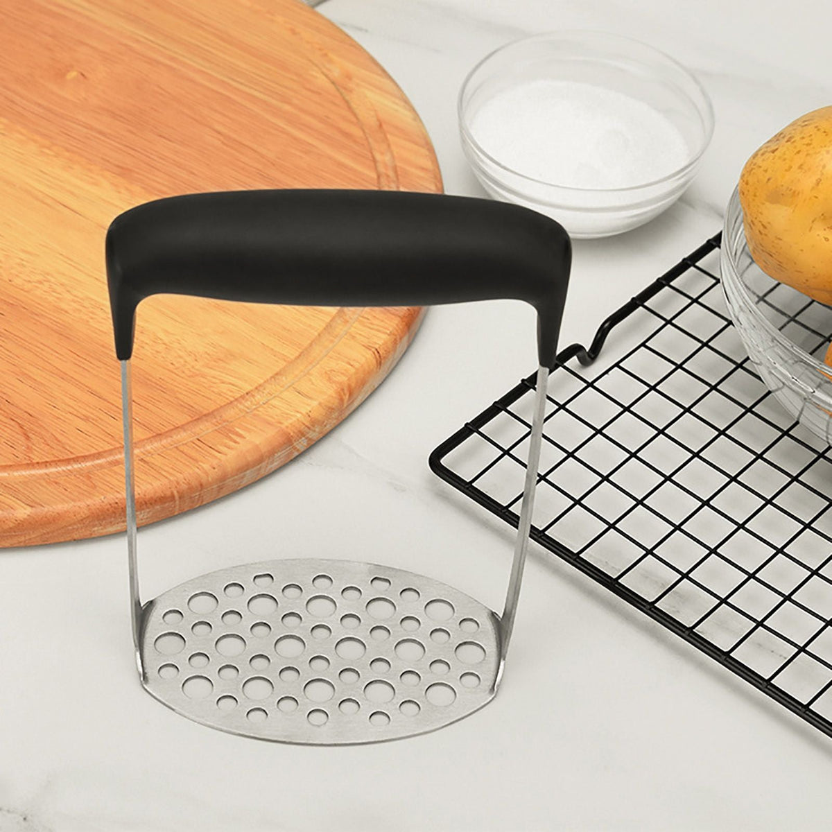 Stainless Steel Potato Masher with a perforated metal plate and wide black horizontal grip handle