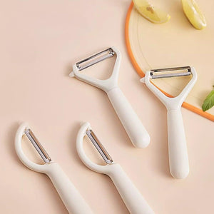 Swivel Vegetable Peeler with white ergonomic handles and stainless steel blades in straight and Y-shaped designs