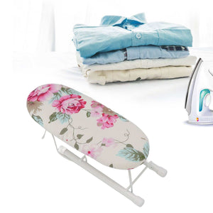 Tabletop Ironing Board with a cream fabric cover, pink peony and green leaf pattern, and folding white metal legs.