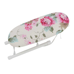 Tabletop Ironing Board with cream fabric cover, pink peony flowers and green leaves, on a white folding frame
