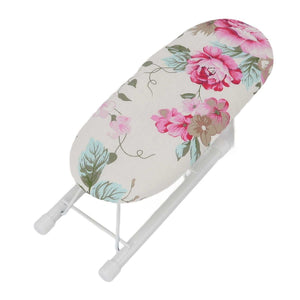 Tabletop Ironing Board with an ivory fabric cover, pink peony flowers and green leaves on a folding white metal frame