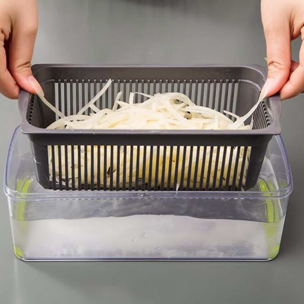 Vegetable Chopper with gray slotted draining basket nested in a clear container, holding thin white vegetable strips