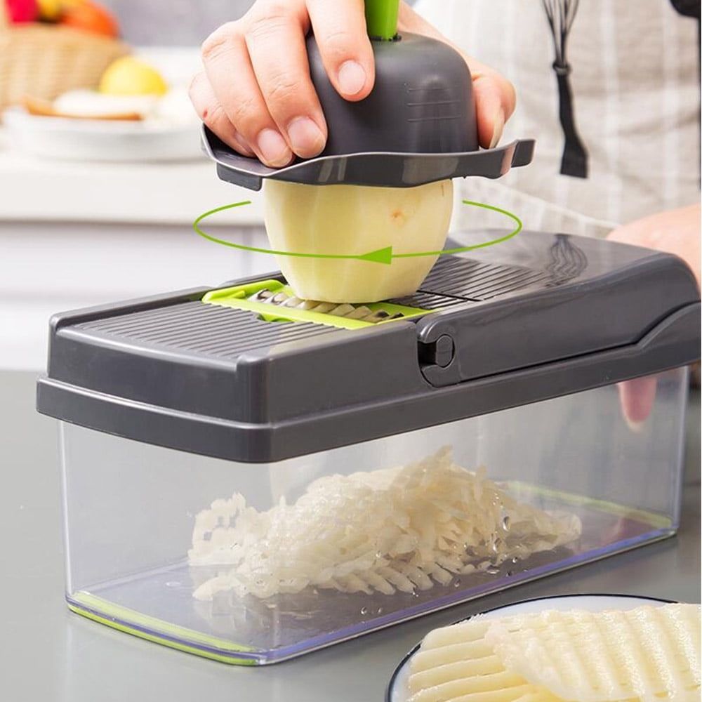 Vegetable Chopper with a dark gray lid, green blade frame and clear collection container, chopping a peeled potato.