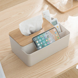 White Multifunctional Tissue Box Organizer with a natural bamboo lid, tissue slot and divided storage compartments holding electronics.