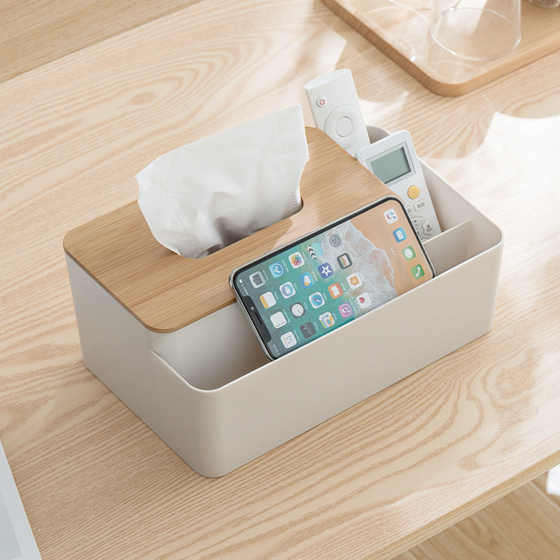 White Multifunctional Tissue Box Organizer with a natural bamboo lid, tissue slot and divided storage compartments holding electronics.